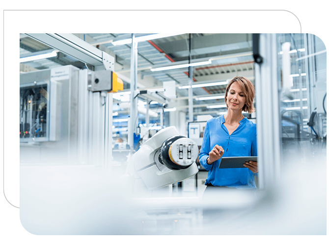 woman monitoring manufacturing equipment.