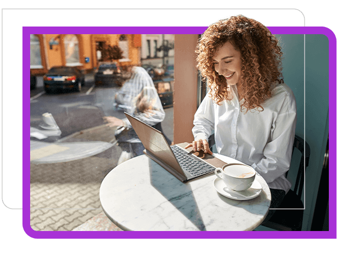 Woman red curly hair working at a sunny coffee shop window