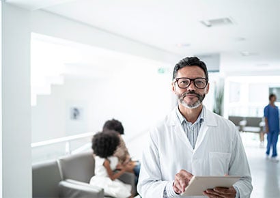 Doctor at hospital checking reports in the tablet.