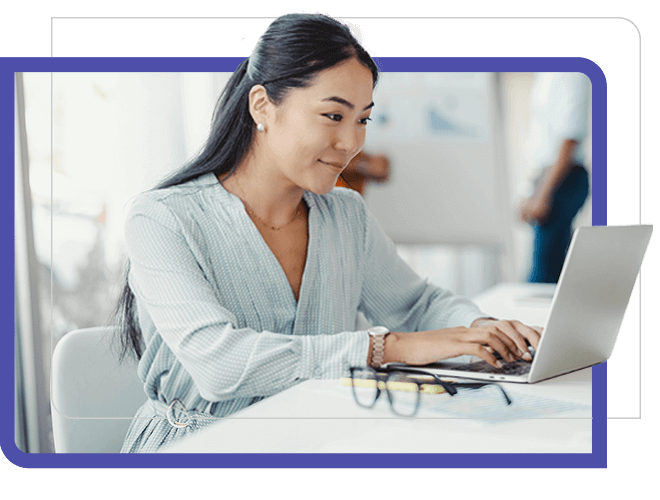 young Asian woman with long hair typing a laptop