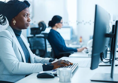 Business woman at work, analyzing screen.