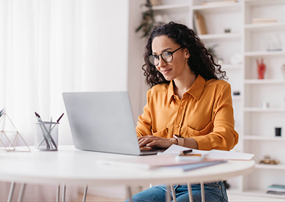 Lady Using Laptop Working Online Wearing Eyewear