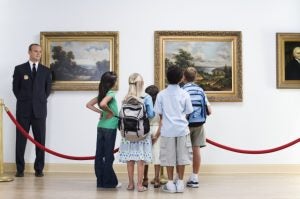 Security Guard and Visitors at Art Gallery